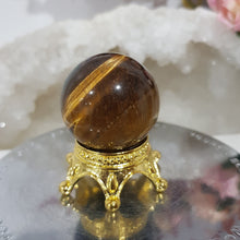 Load image into Gallery viewer, Tigers Eye Sphere Crystal Carving on Gold Stand Stone 30mm 1