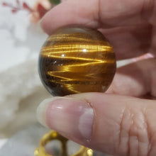 Load image into Gallery viewer, Tigers Eye Sphere Crystal Carving on Gold Stand Stone 30mm 1