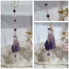 Load image into Gallery viewer, THE MYSTIC AWAKENING" Handcrafted Amethyst Raw Crystal Stone Gold Crystal Energy Enhancer© Hanger Ornament Suncatcher
INSPIRES INTUITION, WISDOM AND SPIRITUALITY
Stunning Raw Amethyst crystal stone beaded with Amethyst and Quartz. Wire wrapped in gold.