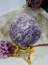 Load image into Gallery viewer, Unicorn Stone Sphere Crystal Carving on Gold Stand. Inspires Calmness, Empathy and Joy.
Unicorn Stone consists of Pink Tourmaline, Lepidolite & Smokey Quartz