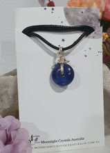 Load image into Gallery viewer, Stunning Blue Kyanite crystal stone donut crystal carving wire wrapped in non tarnish silver wire. Come with a black cork necklace.
