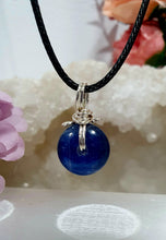 Load image into Gallery viewer, Stunning Blue Kyanite crystal stone donut crystal carving wire wrapped in non tarnish silver wire. Come with a black cork necklace.