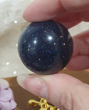 Load image into Gallery viewer, Blue Sandstone Sphere Crystal Carving on Gold Turtle Stand | Inspires Concentration and Courage
Beautiful Blue Sandstone Sphere Crystal Carving on Gold Stand in the shape of a turtle. This is so lovely and sparkly.