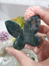 Load image into Gallery viewer, Butterfly Moss Agate Crystal Carving Stone on Stand. Inspires tranquility and grounding.
Beautiful polished Moss Agate Butterfly Crystal Carving on plastic stand