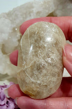 Load image into Gallery viewer, Lovely Moonstone Palm Stone Crystal Carving on plastic stand. Inspires Divine Connection and Clarity