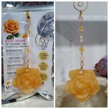 Load image into Gallery viewer, Stunning "ROSE OF SUNSHINE" Handcrafted Orange Calcite Rose Carving gold Crystal Energy Enhancer© Hanger Ornament Suncatcher. hang in your room or space. Inspires Joy, cleansing and love