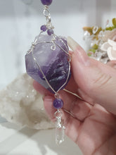 Load image into Gallery viewer, "THE MYSTIC AWAKENING" Handcrafted Amethyst Raw Crystal Stone Silver Crystal Energy Enhancer© Hanger Ornament Suncatcher
INSPIRES INTUITION, WISDOM AND SPIRITUALITY
Stunning Raw Amethyst crystal stone beaded with Amethyst and Quartz. Wire wrapped in silver
Genuine Crystals. no plastic or glass. Ensuring energy flow throughout the enhancer. Hang in your home, work, space and even on your Christmas tree!.
Genuine Crystal Suncatchers Hangers Christmas Tree Ornaments decorations