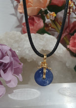 Load image into Gallery viewer, Stunning Blue Kyanite crystal stone donut crystal carving wire wrapped in non tarnish gold wire. Come with a black cork necklace.