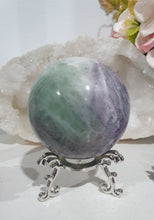 Load image into Gallery viewer, Beautiful Fluorite Sphere Crystal Carving on Silver Stand. Inspires Stability, Grounding and Concentration. Lovely patterns and colouring with inclusions.