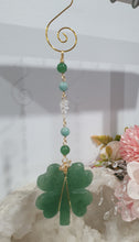 Load image into Gallery viewer, LUCKY FOUR-LEAF CLOVER BLESSINGS" Handcrafted Aventurine Crystal Carving Gold Stone Crystal Energy Enhancer© / Hanger / Ornament / Suncatcher
Promotes GOOD FORTUNE | HOPE | MAGIC | PROTECTION
A four-leaf clover Symbolises good luck and abundance. It is believed if you hold a four-leaf clover you will gain the ability to see fairies and leprechauns and find their treasures.
Beautiful Aventurine four-leaf clover crystal carving beaded with Amazonite, Aventurine and Quartz. Wire wrapped in Gold.