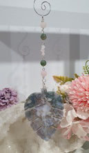 Load image into Gallery viewer, LEAF OF RENEWAL - Handcrafted Moss Agate Leaf silver Crystal Energy Enhancer© / Hanger / Ornament / Suncatcher
SPIRITUAL GROWTH | LOVE | BALANCE
Gorgeous Moss Agate leaf crystal carving beaded with Rose Quartz & Moss Agate. Wire wrapped in silver
Genuine Crystals. no plastic or glass. Ensuring energy flow throughout the enhancer.