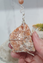 Load image into Gallery viewer, EMPOWERED BY THE SUN" Handcrafted Sunstone Raw Crystal Carving Silver Crystal Energy Enhancer© Hanger Ornament Suncatcher
Inspires EMPOWERMENT | JOY | COURAGE
Lovely Sunstone rough crystal stone beaded with Sunstone and Quartz. Wire wrapped in silver
