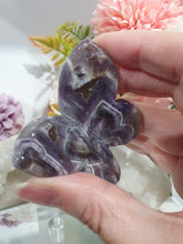 Load image into Gallery viewer, Butterfly Amethyst Crystal Carving Stone on Stand. Inspires Intuition and Spirituality.
Beautiful polished Amethyst Chevron Butterfly Crystal Carving on plastic stand