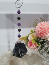 Load image into Gallery viewer, WITCHES AMULET - Handcrafted Obsidian Stone Crystal Energy Enhancer© / Hanger / Ornament / Suncatcher
INSPIRES PROTECTION AND INTUITION
Gorgeous Obsidian raw crystal stone beaded with Black Obsidian and Amethyst. Wire wrapped in silver