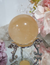Load image into Gallery viewer, Honey Calcite Sphere Crystal Carving on silver stand
INSPIRES SELF WORTH AND CONFIDENCE
lovely Honey Calcite sphere on ornate silver stand