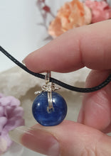 Load image into Gallery viewer, Stunning Blue Kyanite crystal stone donut crystal carving wire wrapped in non tarnish silver wire. Come with a black cork necklace.
