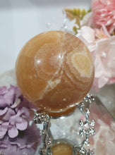 Load image into Gallery viewer, Orange Calcite Sphere Crystal Carving Stone on Silver Stand. This has a crack in it
Inspires JOY AND SELF CONFIDENCE
Lovely Orange Calcite Crystal Sphere on silver stand. Discounted as has a crack. still a gorgeous sphere.