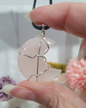 Load image into Gallery viewer, Rose Quartz Moon Crystal Pendant Wire Wrapped Silver Stone with black cord chain
INSPIRES UNCONDITIONAL LOVE & HARMONY
Beautiful Rose Quartz Moon Crystal Carving Wire Wrapper in Silver non tarnish wire. Accompanied by a black cord necklace