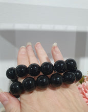 Load image into Gallery viewer, PROTECTION SHIELD" Black Obsidan Beaded Bracelet Crystal Gemstone
7 - 7.5inch with 14mm beads.
INSPIRES PROTECTION AND BALANCE
Lovely chunky Black Obsidian Gemstone Beaded Bracelet. Intuitively (Randomly) chosen.