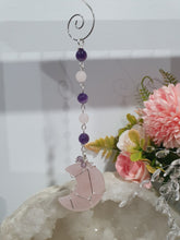 Load image into Gallery viewer, THE PINK MOON" Handcrafted Rose Quartz Moon Carving Stone Silver Crystal Energy Enhancer© Hanger Ornament Suncatcher
INSPIRES LOVE | HARMONY | GROWTH
Beautiful Rose Quartz Moon Crystal Carving beaded with Rose Quartz and Amethyst. wired in silver