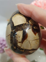Load image into Gallery viewer, Septarian (Dragon Stone) Egg Crystal Carving Stone on Stand.
Grounds & Nurtures
Beautiful Polished Septarian Egg Crystal Carving on plastic stand. Has natural divits formations. Madagascar sourced.
Known as the Dragon Stone. Formed 70 million years ago from volcanic mud and sea life. These polished egg shaped feature cracked patterns of yellow Calcite, brown Aragonite and grey Limestone.The egg shape symbolises new beginnings, the "unfolding of energy from within,".