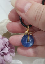 Load image into Gallery viewer, Stunning Blue Kyanite crystal stone donut crystal carving wire wrapped in non tarnish gold wire. Come with a black cork necklace.