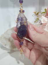 Load image into Gallery viewer, THE MYSTIC AWAKENING" Handcrafted Amethyst Raw Crystal Stone Gold Crystal Energy Enhancer© Hanger Ornament Suncatcher
INSPIRES INTUITION, WISDOM AND SPIRITUALITY
Stunning Raw Amethyst crystal stone beaded with Amethyst and Quartz. Wire wrapped in gold.