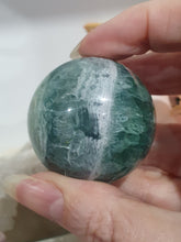 Load image into Gallery viewer, Fluorite Sphere Crystal Carving Stone on Silver Stand
Inspires CONCENTRATION AND STABILITY
Lovely Fluorite Crystal Sphere on silver stand. super pretty. Feather fluorite. Amazing pattern.
