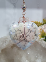 Load image into Gallery viewer, HEART OF A UNICORN" Aura Howlite Heart Stone Rose Gold Crystal Energy Enhancer© Hanger Ornament Suncatcher
INSPIRES MAGICK AND LOVE
Gorgeous Aura Howlite Heart beaded with Rose Quartz, Rainbow Hematite and Quartz. Wired in Rose Gold