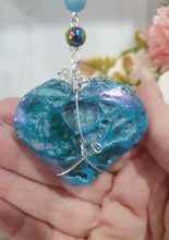 Load image into Gallery viewer, HEART OF THE OCEAN" Handcrafted Titanium Aura Sphalerite Heart Crystal Carving Silver Crystal Energy Enhancer© / Hanger / Ornament / Suncatcher
Inspires PSYCHIC FLOW | LOVE | INTUITION
Gorgeous Titanium Aura Sphalerite heart crystal carving stone beaded with Aquamarine, Rainbow Hematite & Quartz. Wire wrapped in silver
