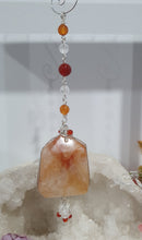 Load image into Gallery viewer, THE FIRE WITHIN" Handcrafted Fire Quartz Tower Crystal Carving Silver Crystal Energy Enhancer© Gemstone / Hanger / Suncatcher / Ornament
STRENGTH | POWER | SPIRITUALITY
Beautiful Fire Quartz Tower Carving Crystal Energy Enhancer© / Sun Catcher / Ornament / Hanger beaded with Fire Quartz, Carnelian and Quartz. wired in Silver