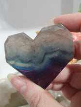 Load image into Gallery viewer, Heart Fluorite Crystal Carving Stone on plastic Stand
Inspires CONCENTRATION AND STABILITY
Lovely Fluorite Heart crystal carving on plastic stand. super pretty.