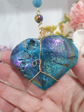Load image into Gallery viewer, HEART OF THE OCEAN" Handcrafted Titanium Aura Sphalerite Heart Stone Crystal Carving Gold Crystal Energy Enhancer© / Hanger / Ornament / Suncatcher
Inspires PSYCHIC FLOW | LOVE | INTUITION
Gorgeous Titanium Aura Sphalerite heart crystal carving beaded with Aquamarine, Rainbow Hematite & Quartz. Wire wrapped in gold