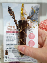Load image into Gallery viewer, WAND OF STRENGTH" Handcrafted Smoky Quartz Tower Point Stone Gold Crystal Energy Enhancer© Hanger Ornament Suncatcher
Inspires GROUNDING | LOVE | STABILITY
Gorgeous Smoky Quartz crystal tower beaded with Smoky Quartz, Rose Quartz and Herkimer Diamond. Wire wrapped in gold