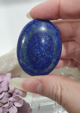 Load image into Gallery viewer, Lapis Lazuli Crystal Palm Stone palm stone on plastic stand.
INSPIRES HARMONY, WISDOM & PSYCHIC PROTECTION
Lovely Lapis Lazuli Crystal Palm stone with pyrite inclusions on plastic stand. So pretty.