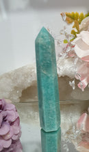 Load image into Gallery viewer, Amazonite Crystal Point Tower Stone. Shes a tad wobbly.
INSPIRES HOPE
Lovely Amazonite crystal point tower. Discounted as a little bit wobbly but still a lovely tower