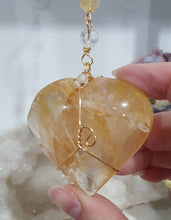 Load image into Gallery viewer, This stunning Ultimate Healer Crystal Energy Enhancer Suncatcher is handcrafted and created with a stunning Golden Healer heart and beaded with golden healer and quartz. Hang in your home or space and feel the ambient energy. Inspires Power and connection. See our other Crystal Suncatchers