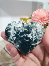Load image into Gallery viewer, Heart Moss Agate Crystal Carving Stone on stand
INSPIRES GROUNDING AND CONNECTION TO EARTH
Lovely Moss Agate Heart Crystal Carving on silver stand.