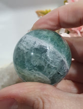 Load image into Gallery viewer, Fluorite Sphere Crystal Carving Stone on Silver Stand
Inspires CONCENTRATION AND STABILITY
Lovely Fluorite Crystal Sphere on silver stand. super pretty. Feather fluorite. Amazing pattern.