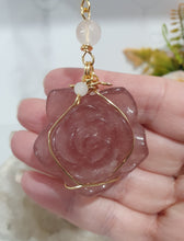 Load image into Gallery viewer, "THE BLUSHING ROSE" Strawberry Quartz Rose Carving gold Crystal Energy Enhancer© Hanger Ornament Suncatcher.
HAPPINESS / LOVE / HARMONY
"THE BLUSHING ROSE - Like the petals of a rose unfolding, The Blushing Rose encourages us to embrace self-love, joy and the beauty within."
Gorgeous Strawberry Quartz Rose Crystal Carving beaded with Ice Pink Malaysian Jade, Rose Quartz, Amazonite and Quartz. Wire wrapped in gold