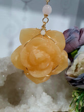 Load image into Gallery viewer, Stunning "ROSE OF SUNSHINE" Handcrafted Orange Calcite Rose Carving gold Crystal Energy Enhancer© Hanger Ornament Suncatcher. hang in your room or space. Inspires Joy, cleansing and love