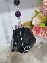 Load image into Gallery viewer, WITCHES AMULET - Handcrafted Obsidian Stone Crystal Energy Enhancer© / Hanger / Ornament / Suncatcher
INSPIRES PROTECTION AND INTUITION
Gorgeous Obsidian raw crystal stone beaded with Black Obsidian and Amethyst. Wire wrapped in silver