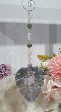 Load image into Gallery viewer, LEAF OF RENEWAL - Handcrafted Moss Agate Leaf silver Crystal Energy Enhancer© / Hanger / Ornament / Suncatcher
SPIRITUAL GROWTH | LOVE | BALANCE
Gorgeous Moss Agate leaf crystal carving beaded with Rose Quartz & Moss Agate. Wire wrapped in silver
Genuine Crystals. no plastic or glass. Ensuring energy flow throughout the enhancer.