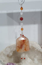 Load image into Gallery viewer, THE FIRE WITHIN" Handcrafted Fire Quartz Tower Crystal Carving Silver Crystal Energy Enhancer© Gemstone / Hanger / Suncatcher / Ornament
STRENGTH | POWER | SPIRITUALITY
Beautiful Fire Quartz Tower Carving Crystal Energy Enhancer© / Sun Catcher / Ornament / Hanger beaded with Fire Quartz, Carnelian and Quartz. wired in Silver