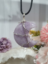Load image into Gallery viewer, Lepidolite Moon Crystal Pendant Wire Wrapped Silver Stone with black cord chain
STONE OF TRANSITION
Beautiful Lepidolite Moon Crystal Carving Wire Wrapper in Silver non tarnish wire. Accompanied by a black cord necklace