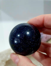 Load image into Gallery viewer, Sparkly Blue Sandstone Sphere Crystal Carving on Silver Stand. Inspires Concentration and Courage. Gorgeous