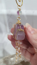 Load image into Gallery viewer, Lovely "EVERY CLOUD HAS A SILVER LINING" Fluorite Cloud gold wired Crystal Energy Enhancer© Hanger Ornament Suncatcher.
From Darkness comes Light.
TRANSFORMATION / INTUITION / SPIRITUALITY
Beautiful Fluorite Cloud Crystal Carving beaded with Fluorite & Quartz. wired in Gold