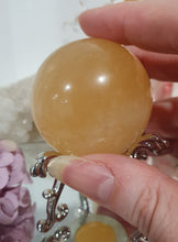 Load image into Gallery viewer, Honey Calcite Sphere Crystal Carving on silver stand
INSPIRES SELF WORTH AND CONFIDENCE
lovely Honey Calcite sphere on ornate silver stand