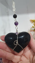 Load image into Gallery viewer, THE WITCHES HEART" Handcrafted Obsidian Heart Crystal Carving Stone Silver Crystal Energy Enhancer© Hanger Ornament Suncatcher
INSPIRES MAGIC, INTUITION AND PROTECTION
Gorgeous Obsidian heart crystal carving stone beaded with Black Obsidian, Amethyst and Herkimer Diamonds. Wire wrapped in silver