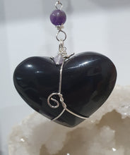 Load image into Gallery viewer, THE WITCHES HEART" Handcrafted Obsidian Heart Crystal Carving Stone Silver Crystal Energy Enhancer© Hanger Ornament Suncatcher
INSPIRES MAGIC, INTUITION AND PROTECTION
Gorgeous Obsidian heart crystal carving stone beaded with Black Obsidian, Amethyst and Herkimer Diamonds. Wire wrapped in silver